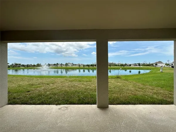 a view of a field with an ocean view