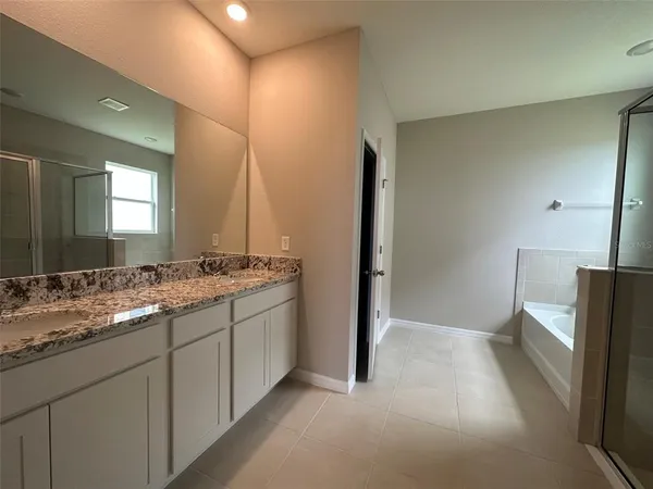a bathroom with a double vanity sink and mirror