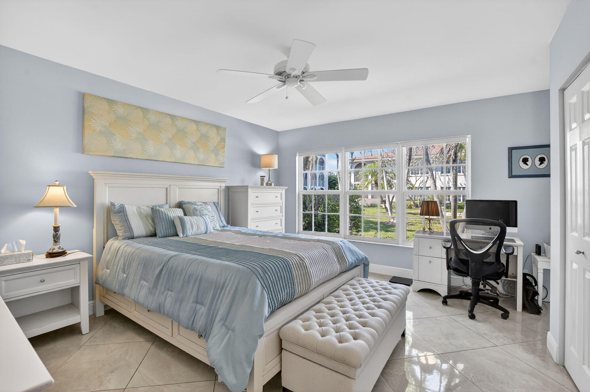 250 Northeast 20th Street, Unit 1170 Boca Raton, FL 33431 - Photo 16 of 40 a bedroom with a bed and a chandelier