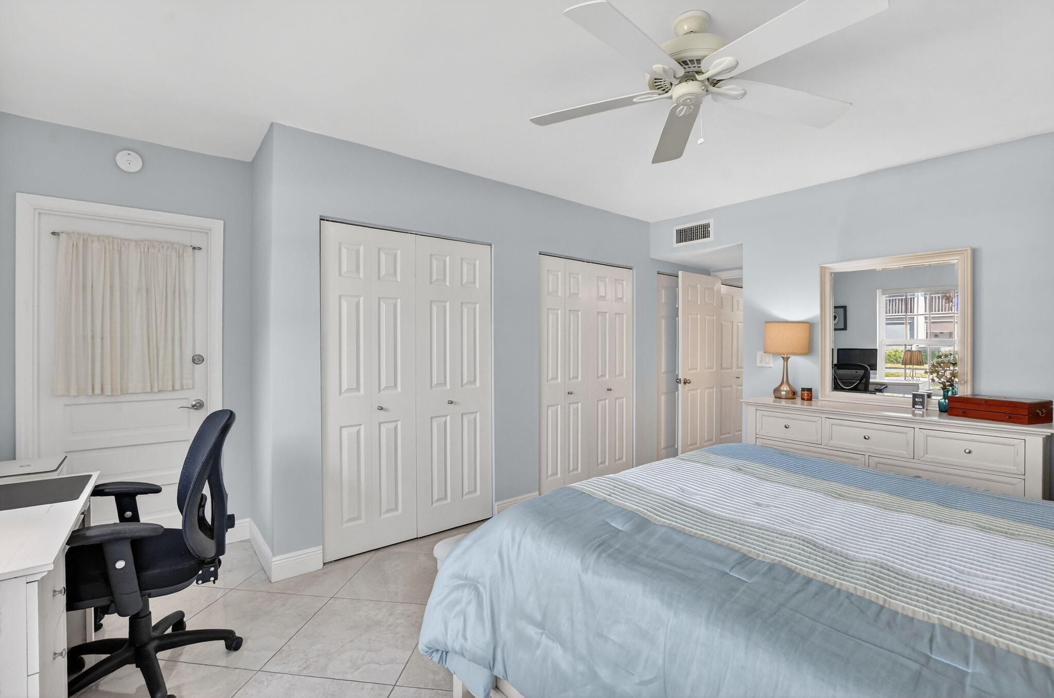 250 Northeast 20th Street, Unit 1170 Boca Raton, FL 33431 - Photo 17 of 40 a bedroom with a bed a desk and chair