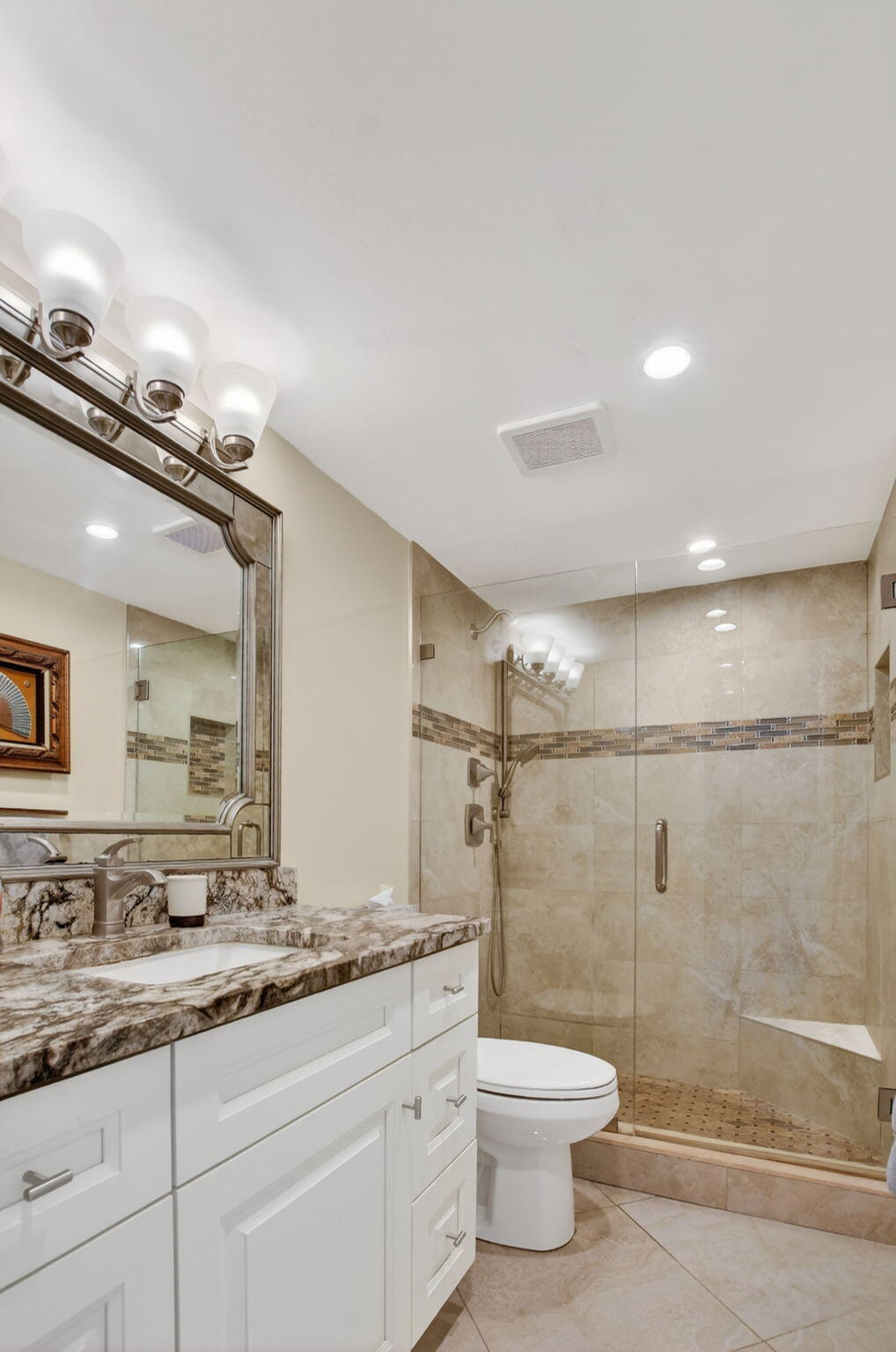 250 Northeast 20th Street, Unit 1170 Boca Raton, FL 33431 - Photo 20 of 40 a bathroom with a granite countertop shower sink vanity mirror and toilet