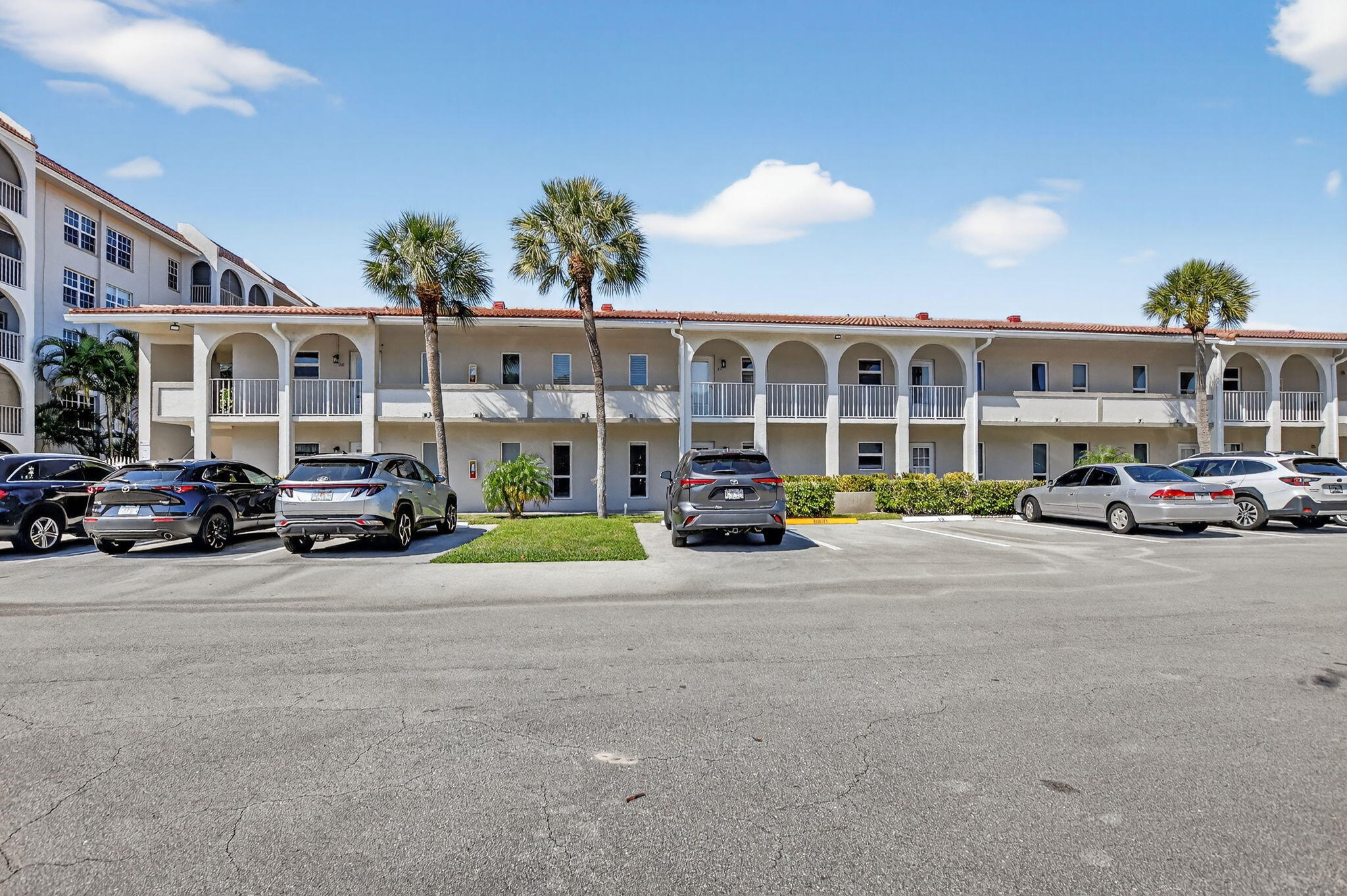 250 Northeast 20th Street, Unit 1170 Boca Raton, FL 33431 - Photo 2 of 40 a view of a cars parked in front of a building