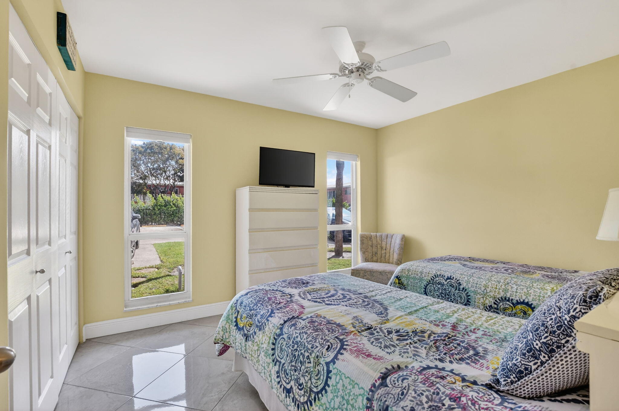 250 Northeast 20th Street, Unit 1170 Boca Raton, FL 33431 - Photo 21 of 40 a bedroom with a bed and a flat screen tv