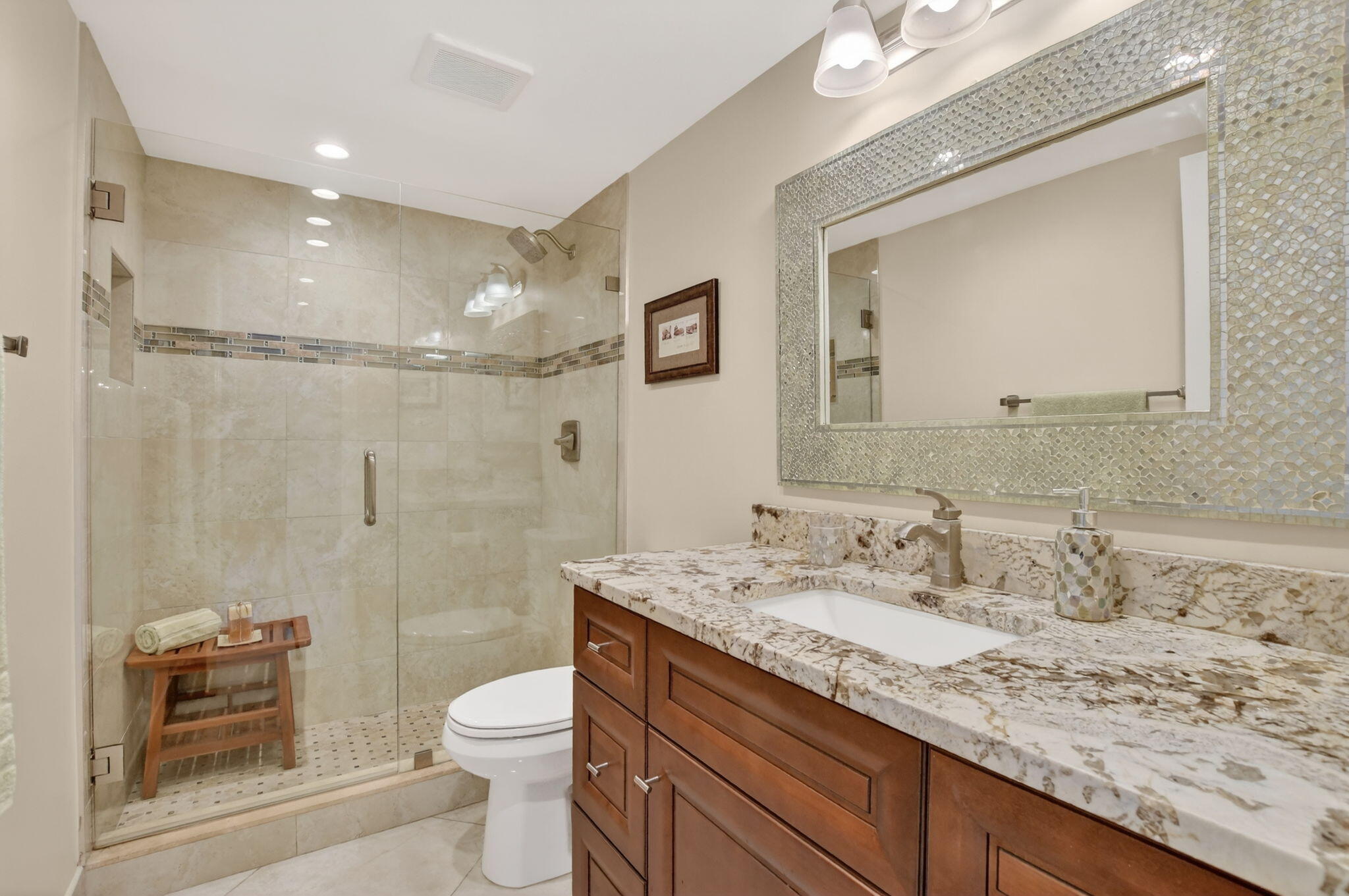 250 Northeast 20th Street, Unit 1170 Boca Raton, FL 33431 - Photo 24 of 40 a bathroom with a granite countertop sink a toilet and shower