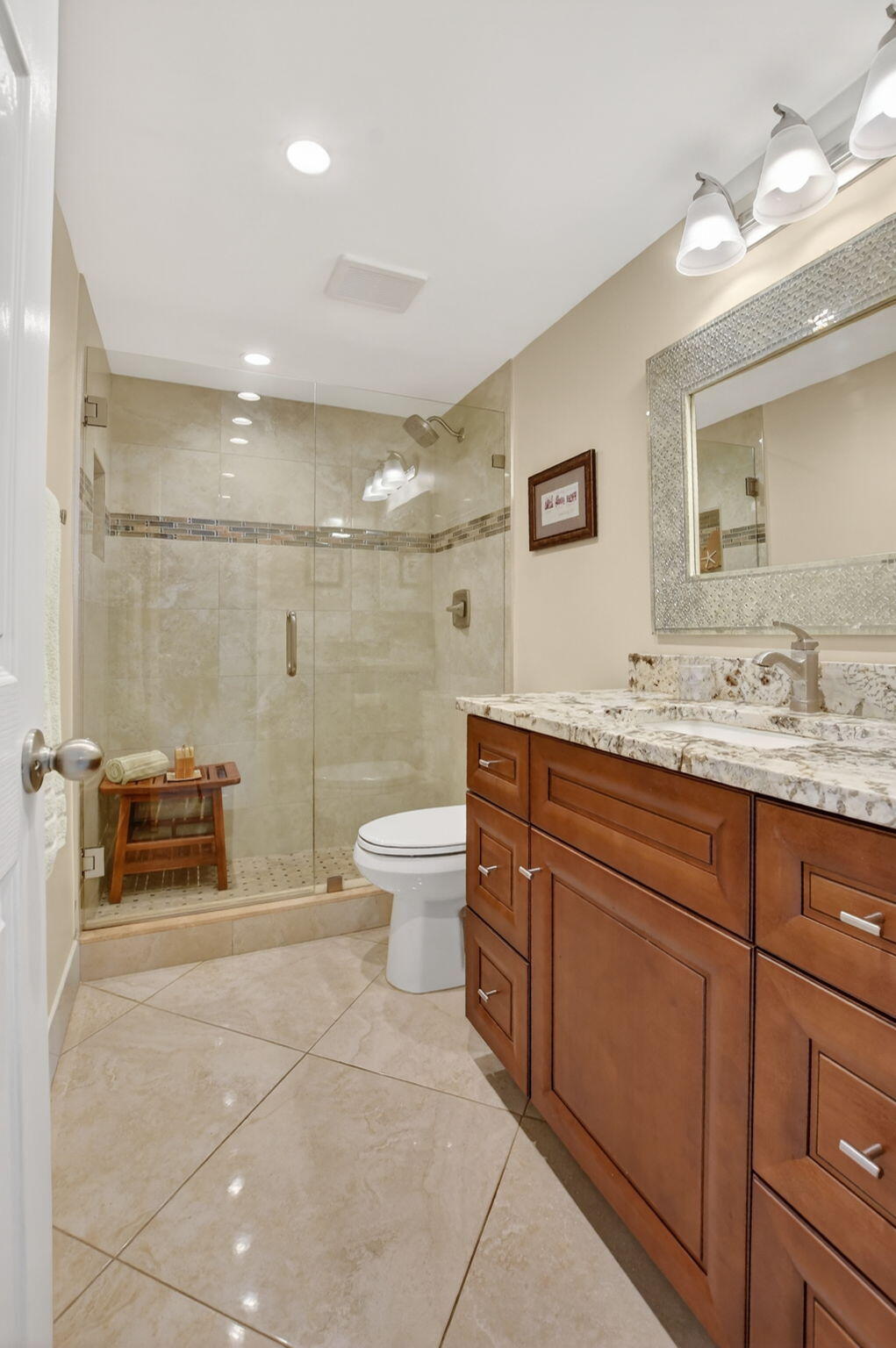 250 Northeast 20th Street, Unit 1170 Boca Raton, FL 33431 - Photo 25 of 40 a bathroom with a granite countertop sink a toilet and a mirror