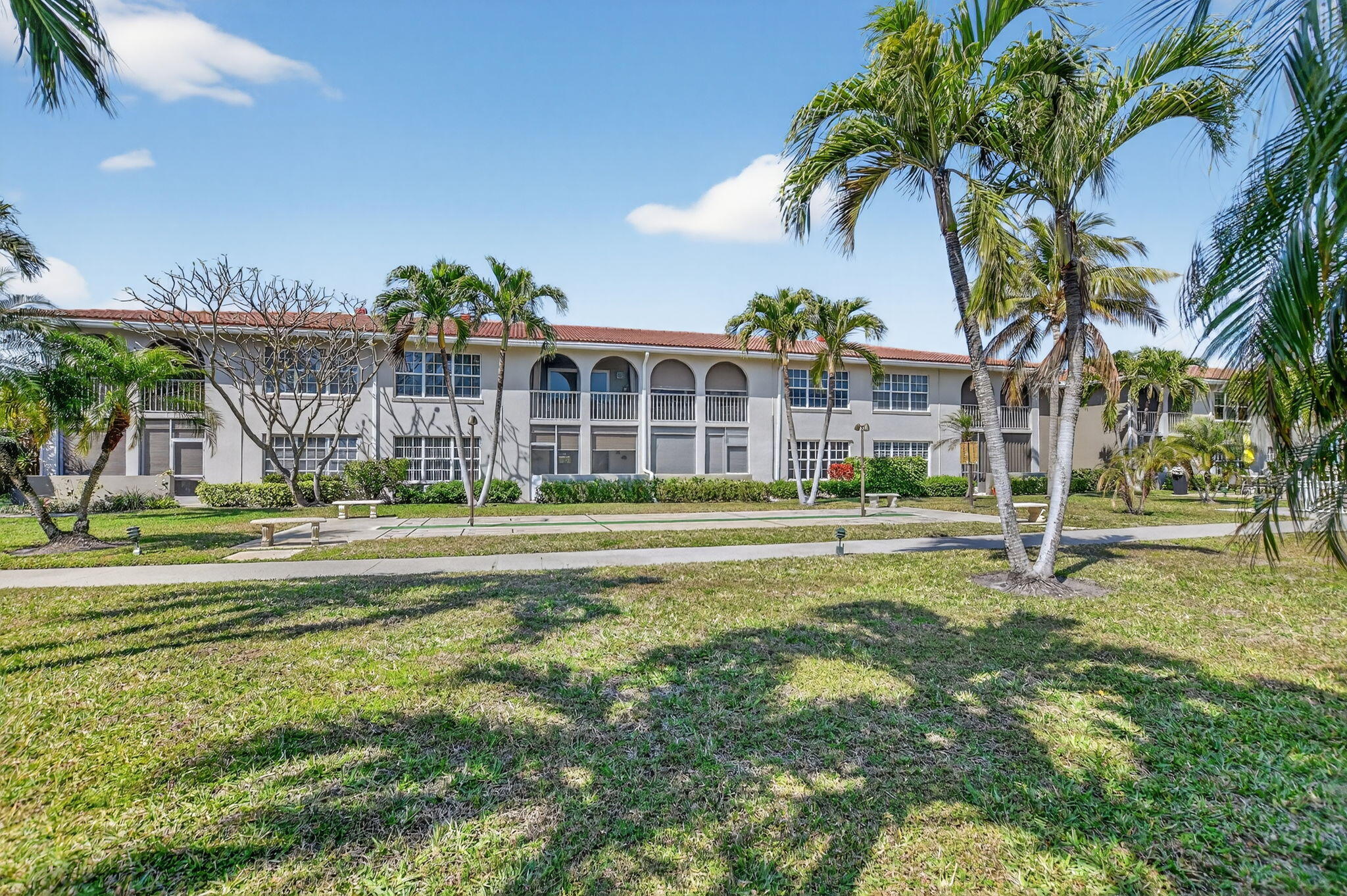 250 Northeast 20th Street, Unit 1170 Boca Raton, FL 33431 - Photo 31 of 40 a view of a house with a big yard and palm trees