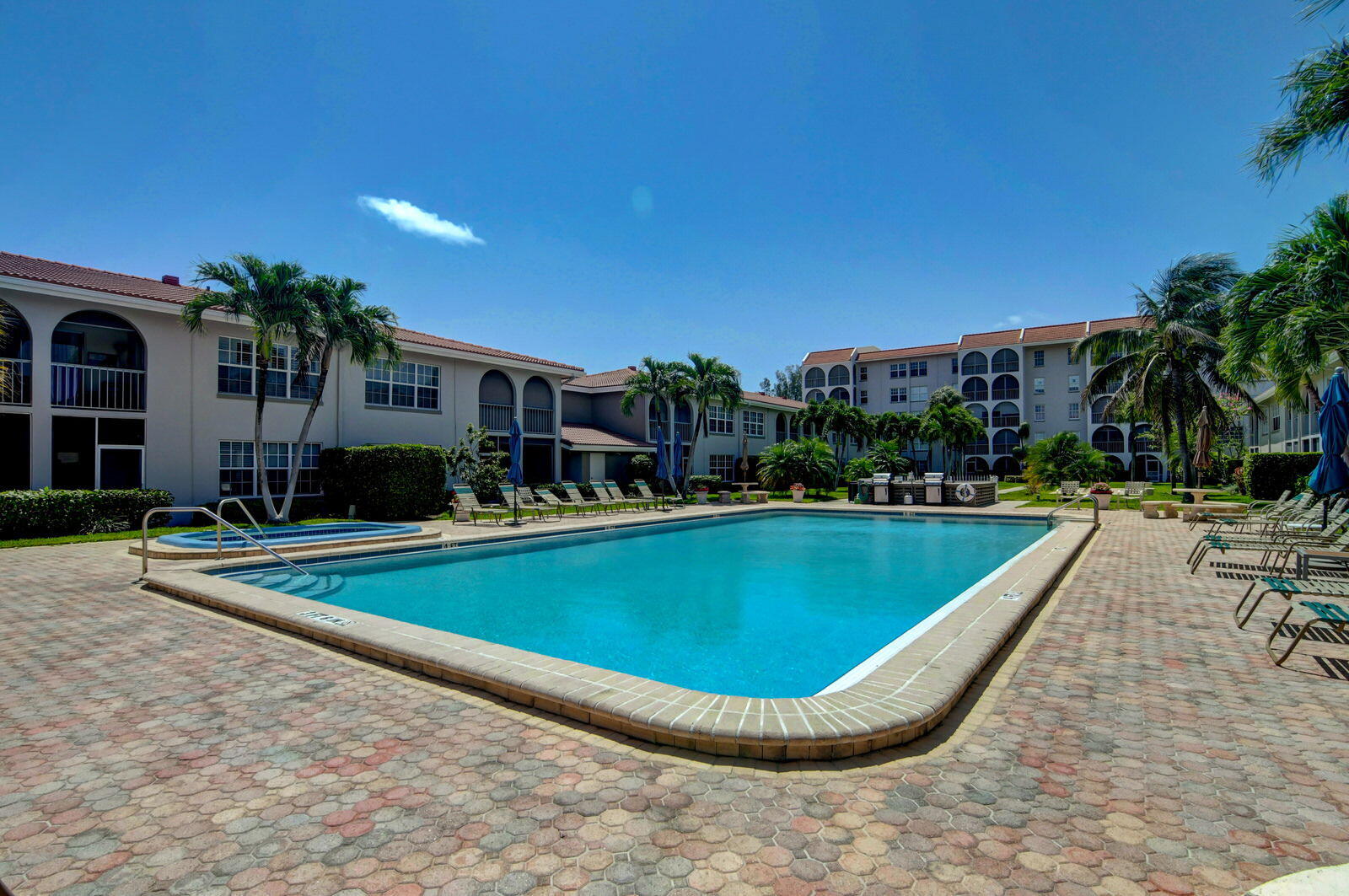 250 Northeast 20th Street, Unit 1170 Boca Raton, FL 33431 - Photo 32 of 40 a view of a swimming pool with lawn chairs and plants