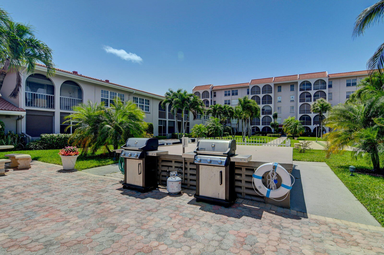 250 Northeast 20th Street, Unit 1170 Boca Raton, FL 33431 - Photo 35 of 40 a view of a patio with couches and table and chairs and potted plants