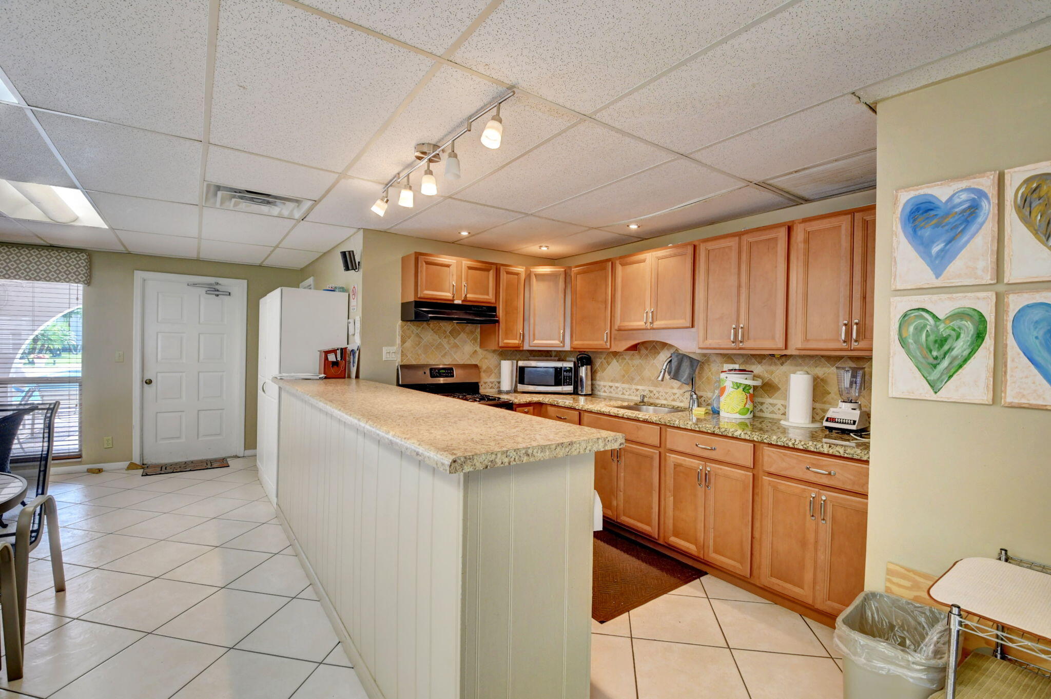 250 Northeast 20th Street, Unit 1170 Boca Raton, FL 33431 - Photo 39 of 40 a kitchen with a sink a counter top space cabinets stainless steel appliances and a window
