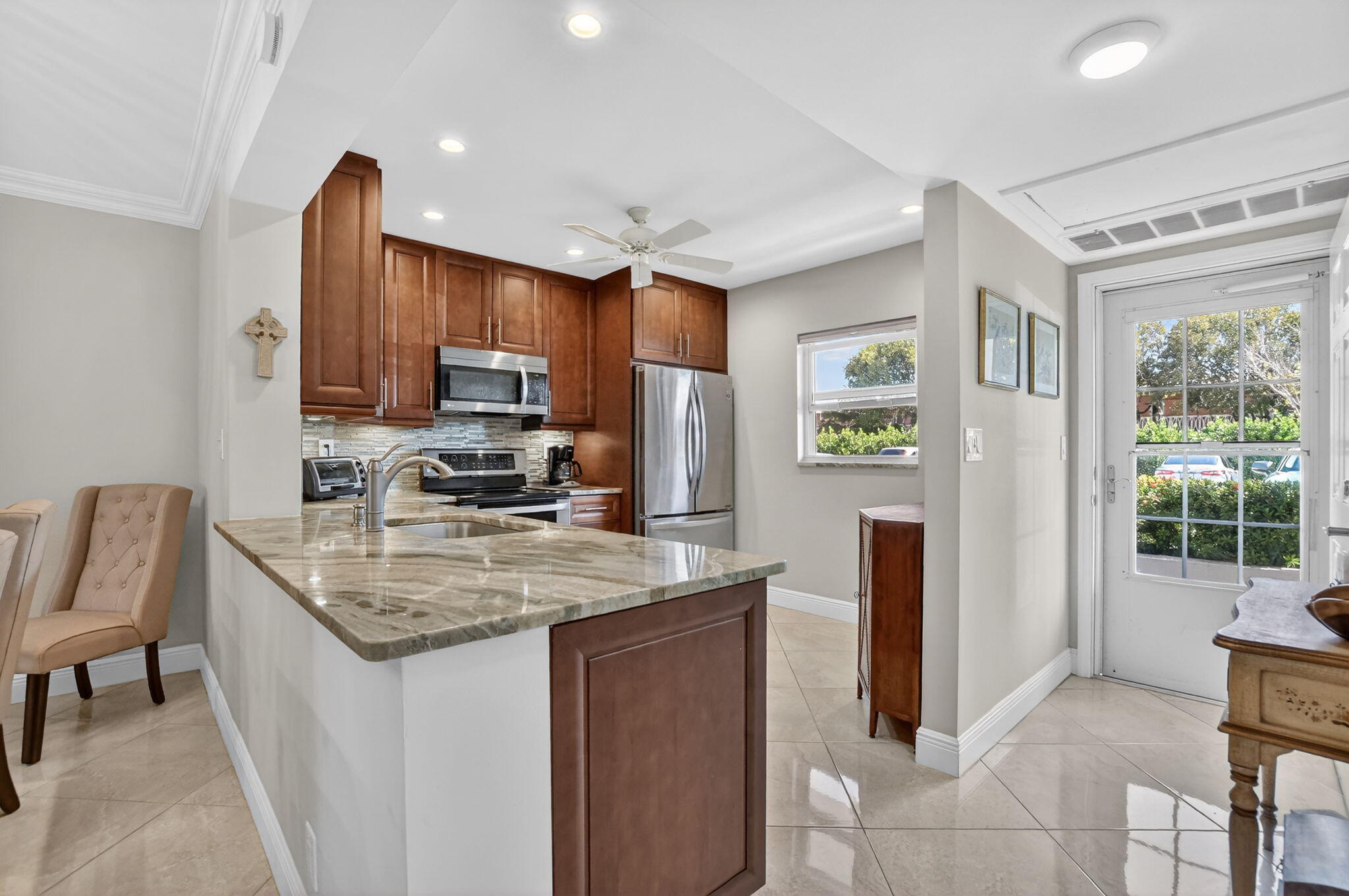 250 Northeast 20th Street, Unit 1170 Boca Raton, FL 33431 - Photo 6 of 40 a kitchen with stainless steel appliances granite countertop a refrigerator and a stove top oven