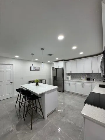 a living room with a bed and a cabinets