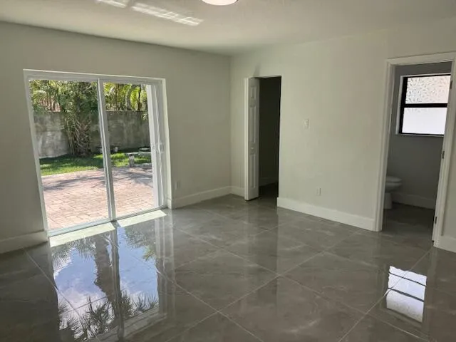 a view of an empty room with glass door
