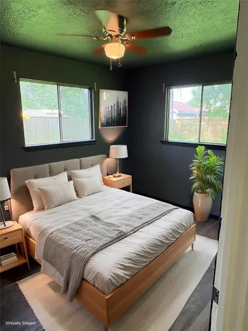 a bedroom with a large bed and a potted plant