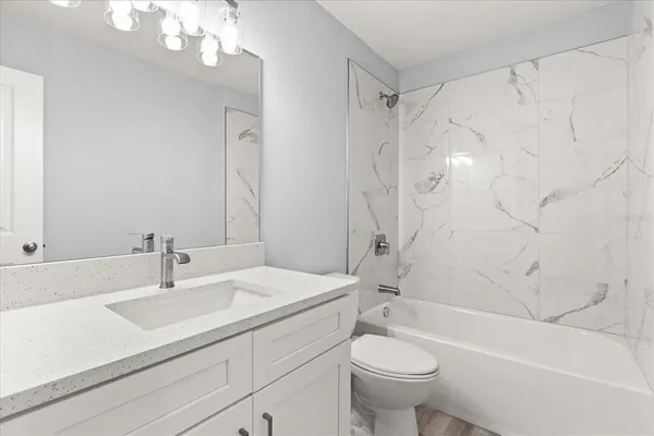 a bathroom with a sink a toilet and a bathtub