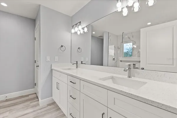 a bathroom with a double vanity sink and a mirror