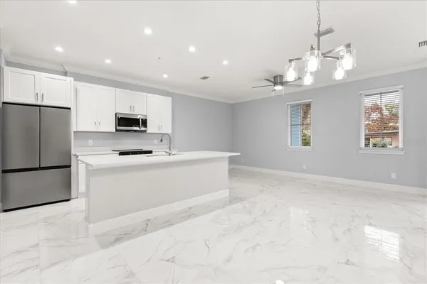 a view of kitchen with center island and stainless steel appliances