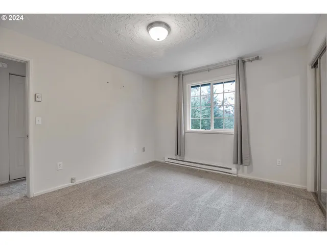 a view of a room with wooden floor and windows
