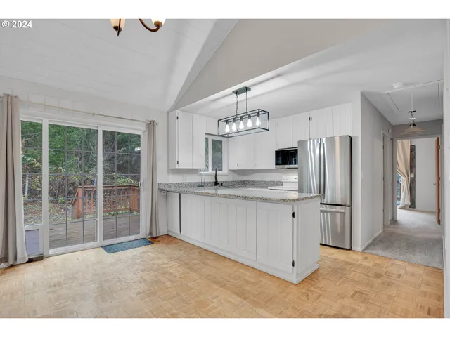 a kitchen with refrigerator cabinets and a sink