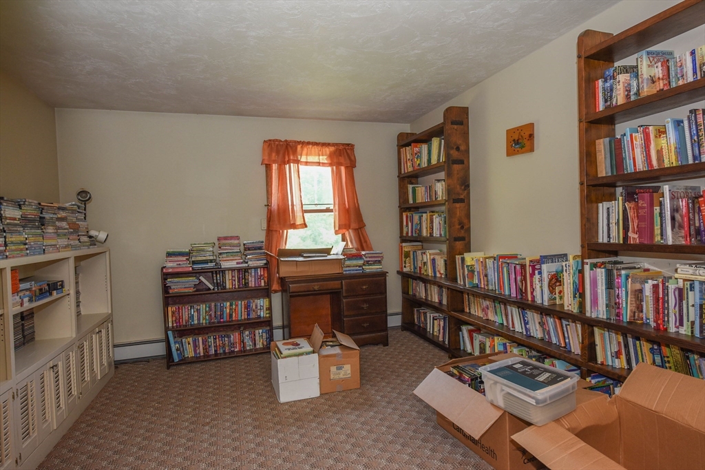 179 County Road Ashby, MA 01431 - Photo 14 of 33 a view of a workspace with furniture and a book shelf