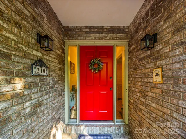 a view of empty room with wooden floor and fireplace