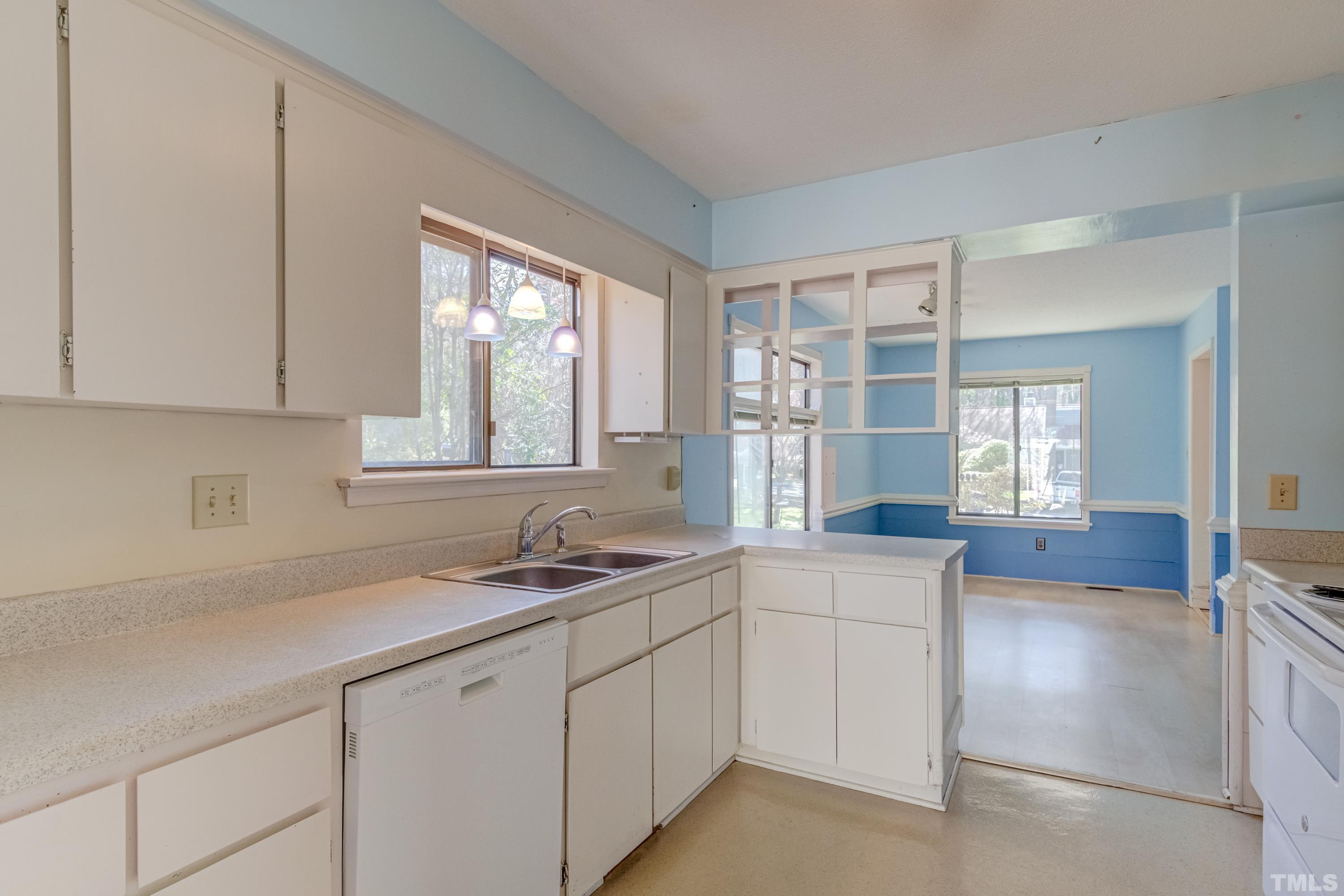 5869 Branchwood Road Raleigh, NC 27609 - Photo 21 of 35 a kitchen with a sink and cabinets
