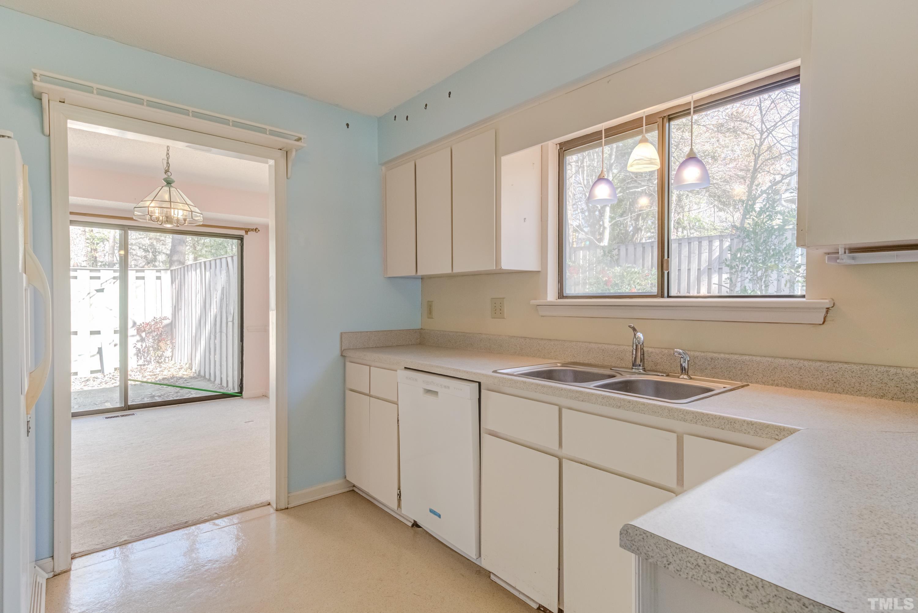 5869 Branchwood Road Raleigh, NC 27609 - Photo 22 of 35 a kitchen with a sink cabinets and window
