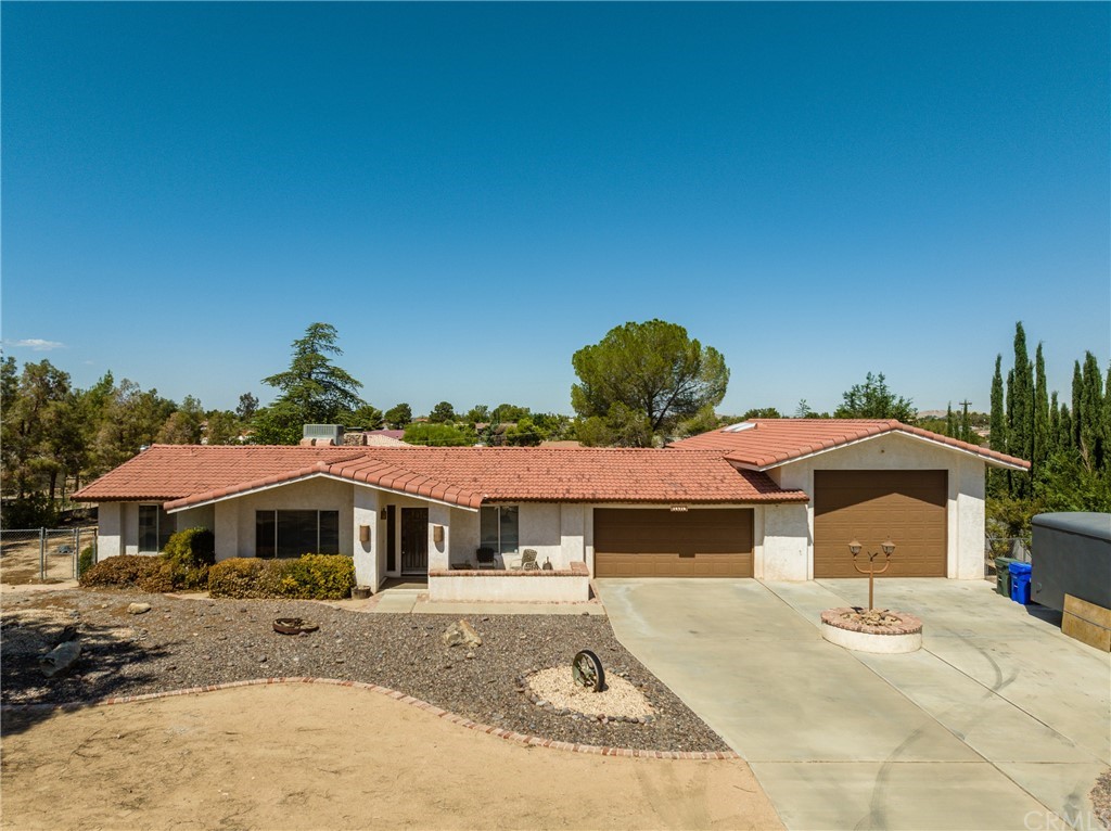 14718 Choco Road Apple Valley, CA 92307 - Photo 1 of 1 a front view of a house with a yard