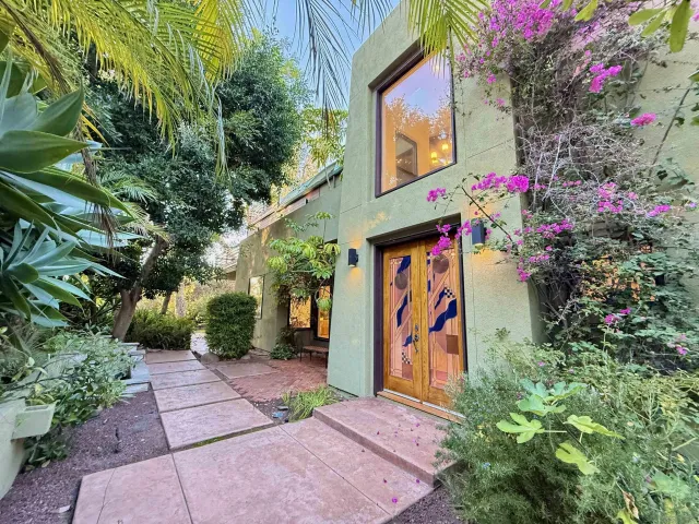 a view of path along with flowers and trees