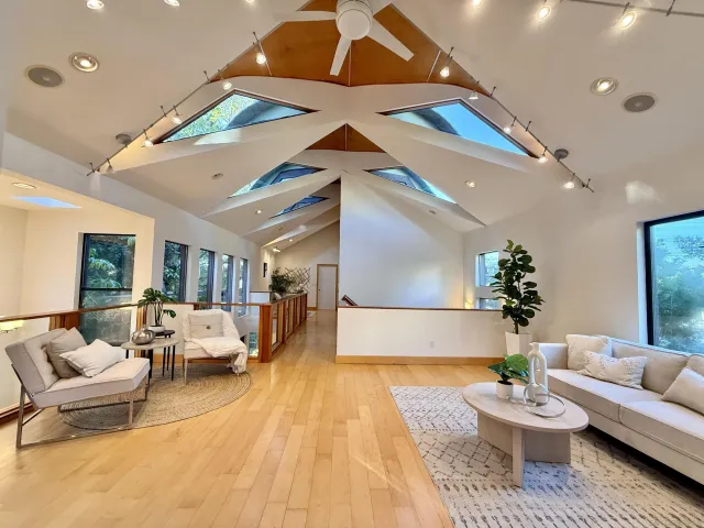 a living room with furniture and a wooden floor
