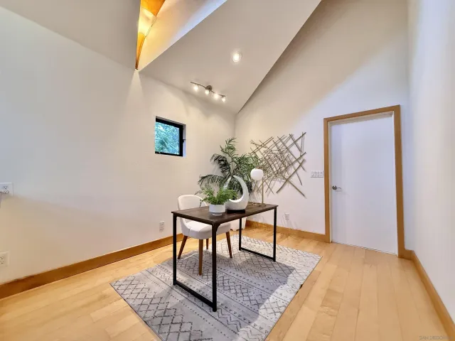 a spacious bedroom with a bed and glass walk in closet