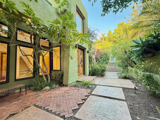 a house with potted plants in front of it