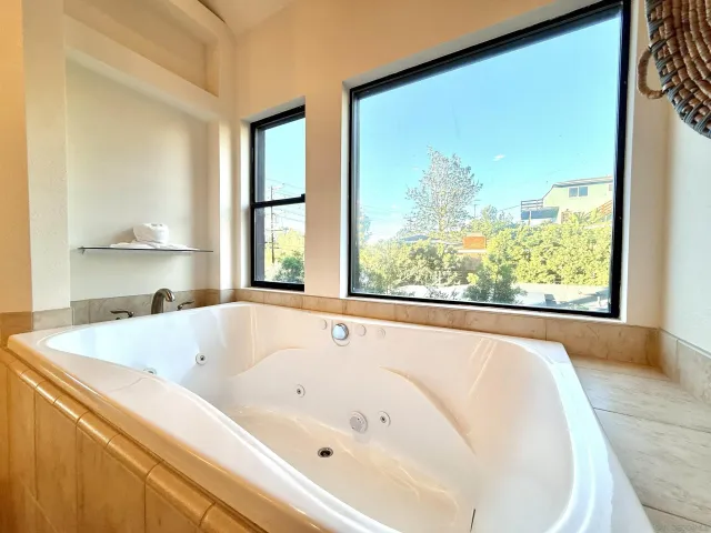 a bathroom with a granite countertop double vanity sink and a mirror