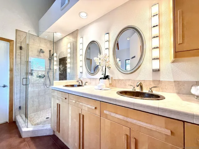 a front view of a house with a yard and potted plants