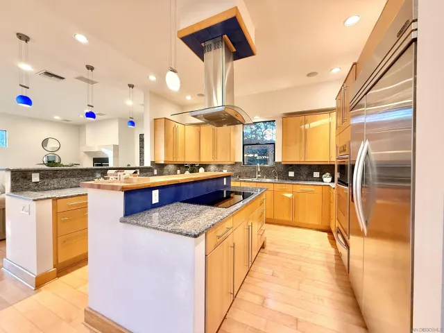 a kitchen with stainless steel appliances granite countertop a stove and a sink
