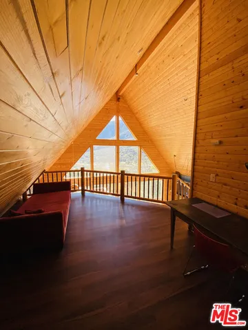 a view of balcony with wooden floor and furniture