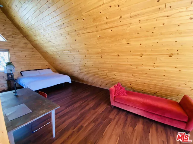 a view of a floor to ceiling window with wooden floor