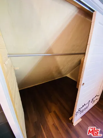 a balcony with wooden floor and mountains in the background
