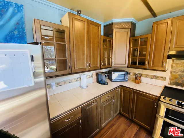 a living room with furniture and kitchen view