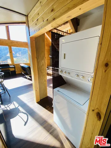 a bedroom with a bed and a lamp on dresser