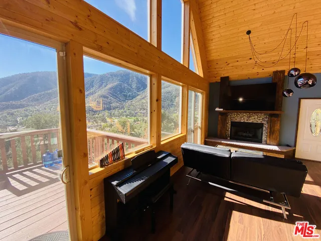 a living room with table chairs and a flat screen tv