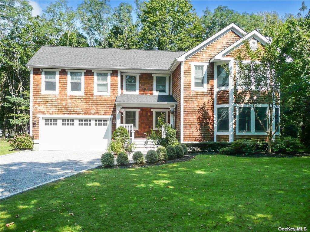 5 Livingston Road Bellport, NY 11713 - Photo 1 of 1 a front view of a house with a yard and porch