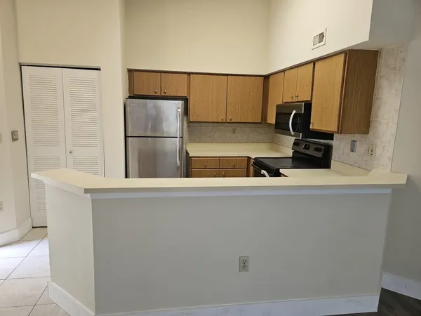 a kitchen with a refrigerator and a sink