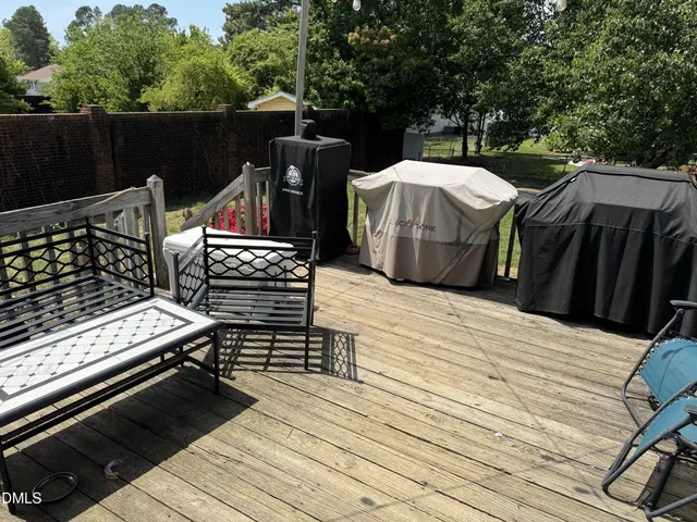 a view of a wooden deck with furniture