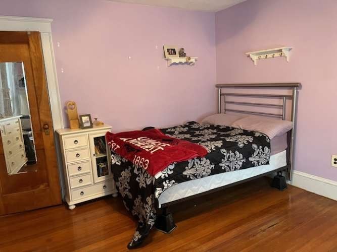 43 Loring Road Winthrop, MA 02152 - Photo 13 of 21 a bed sitting in a bedroom next to a window