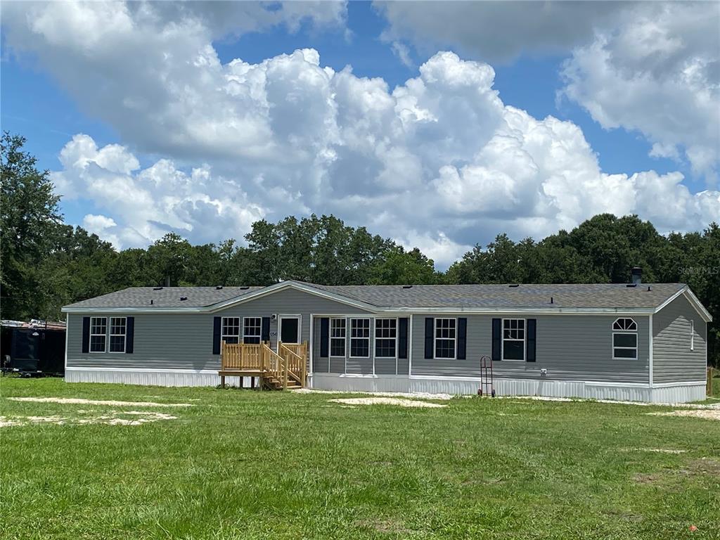 12545 Farmettes Road Lakeland, FL 33809 - Photo 1 of 1 a front view of a house with a garden
