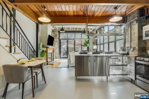 a dining room with furniture and a floor to ceiling window