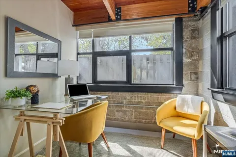a kitchen with a table chairs and refrigerator in it
