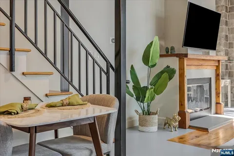a dining room with furniture a potted plant and a potted plant