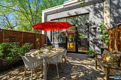 a view of a patio with table and chairs under an umbrella