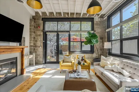 a living room with fireplace furniture and a flat screen tv